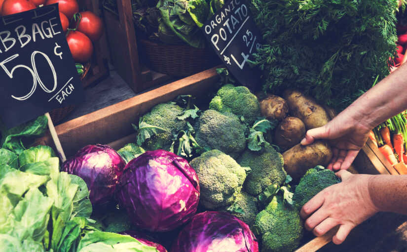 An assortment of fresh vegetables including green cabbage and potatoes
