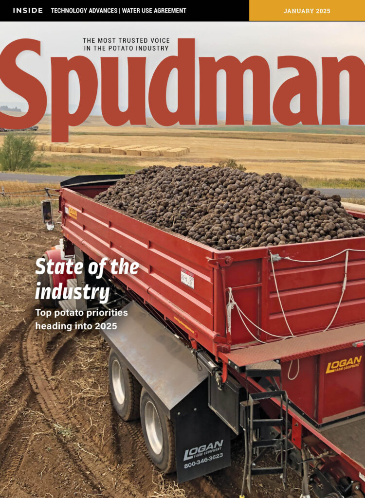 A bright red truck hauls a load of fresh harvested potatoes