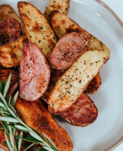 Seasoned potato wedges piled high on a white plate