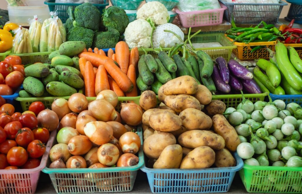Baskets of carrots, onions, potatoes and other vegetables