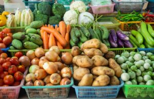 Baskets of carrots, onions, potatoes and other vegetables
