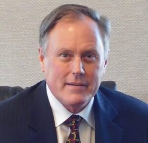 Head shot of Michael Marsh, a man wearing a suit and tie