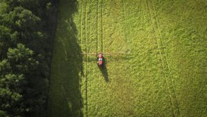 An overhead view of a piece of farm equipment in a vast green field