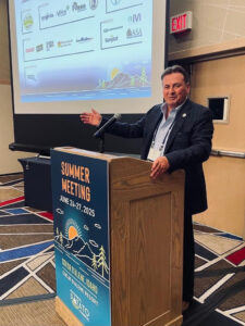 A man gestures at a podium