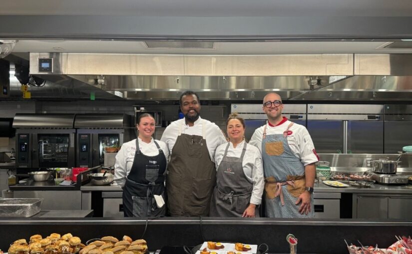 Four chefs pose in front of a recently cooked potato products