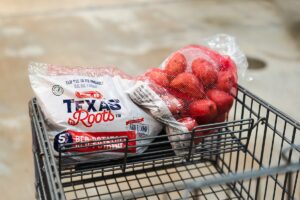 A package of red potatoes in a shopping cart