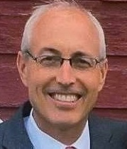 Head shot of smiling man with glasses