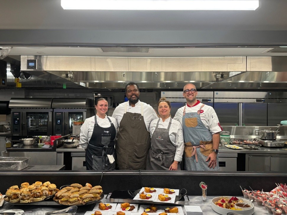 Four chefs pose in front of a recently cooked potato products