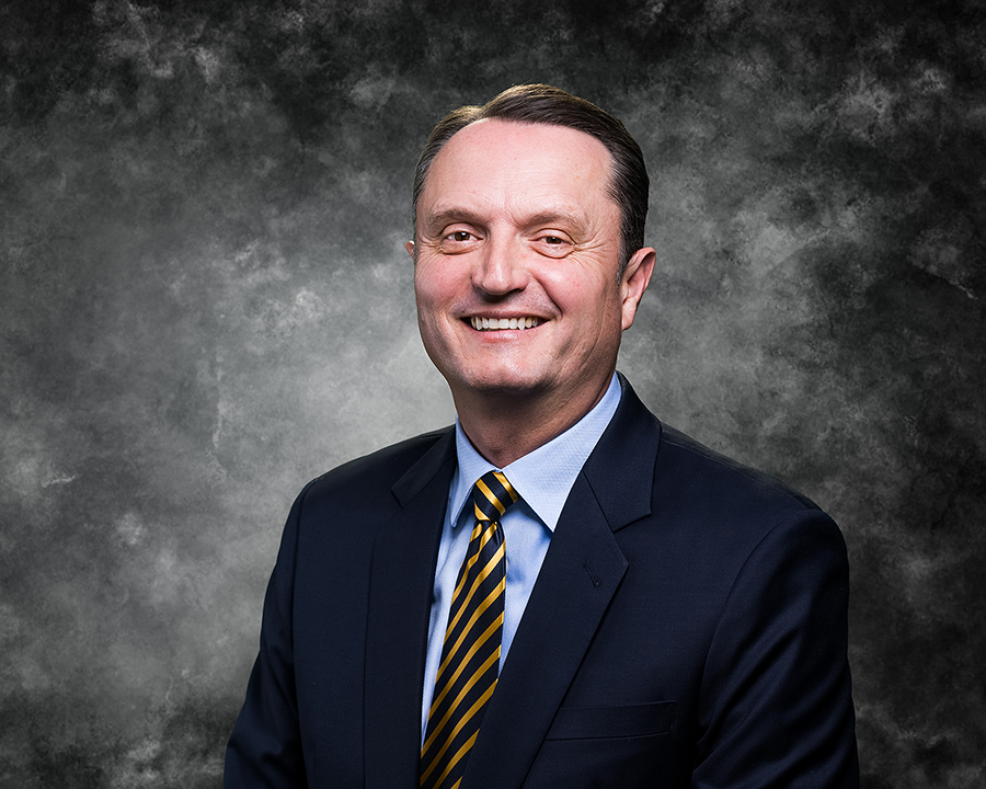 Head shot of man in dark suit jacket 