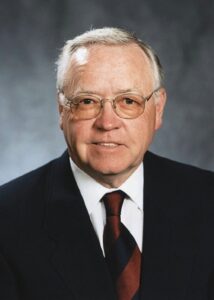 head shot of man in dark suit 