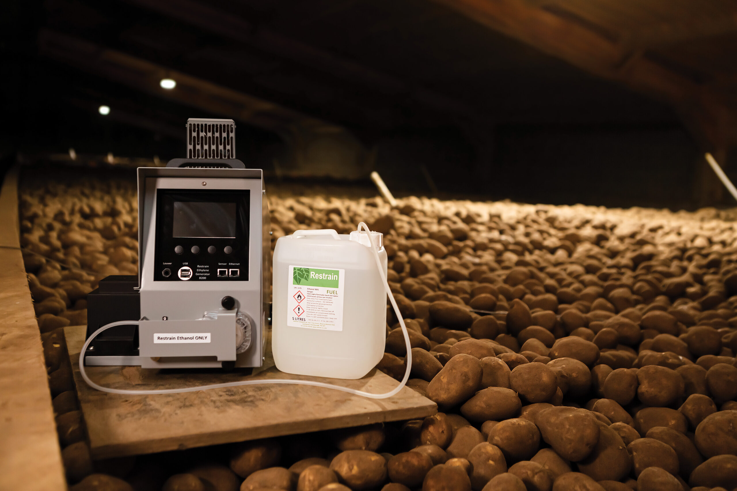 Sensing equipment highlighted against a mound of stored potatoes