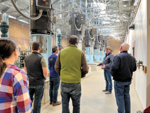 People face equipment in a pumping facility 