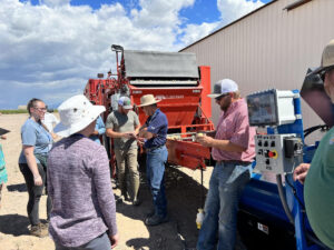 A group gathers outside a Colorado potato production operation